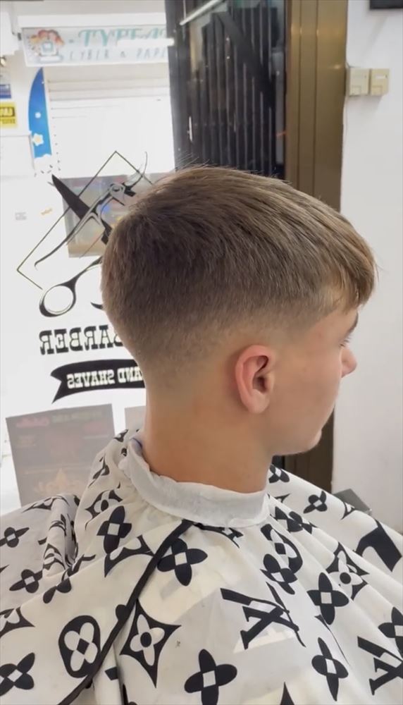 Mid taper fade with a longer fringe on top